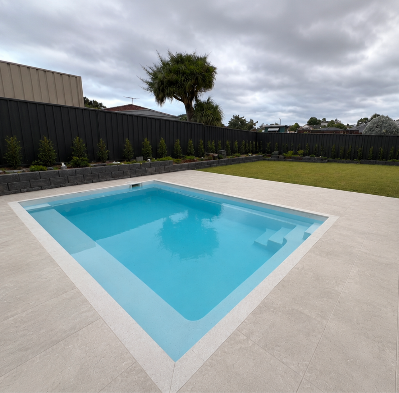Plunge pool with full travertine paving and tile band — Macarthur region