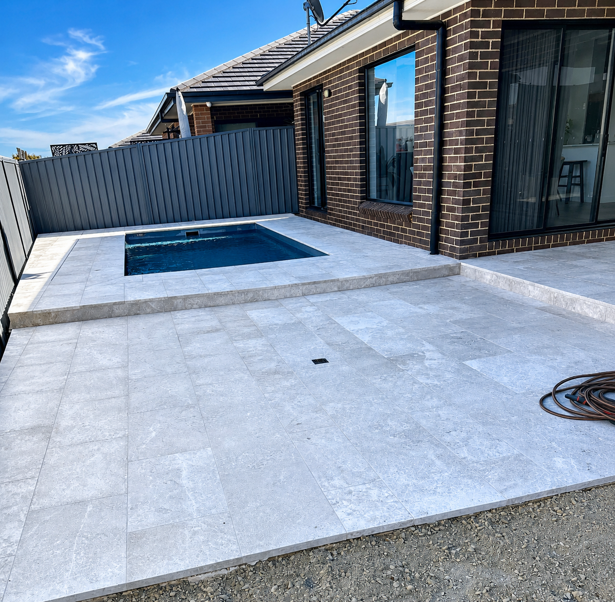 Plunge pool with full travertine paving and tile band — Macarthur region