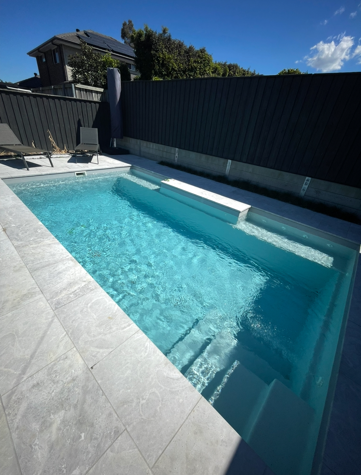 Fibreglass pool with travertine surrounds — Macarthur region install